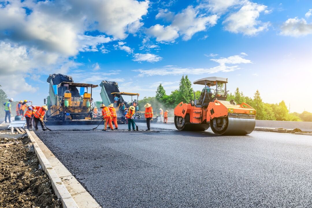 Paving crew and machinery on a commercial job in Dallas–Fort Worth, TX — Blackland Asphalt