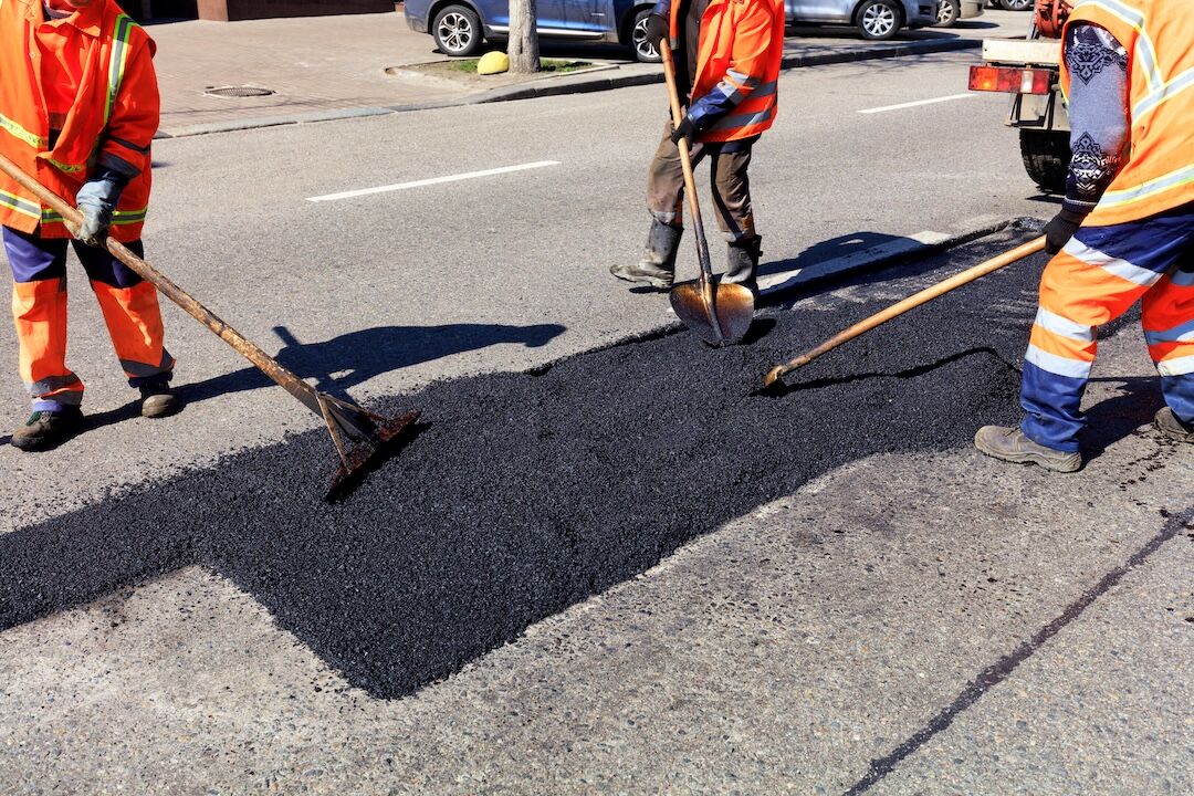 Crew repairing commercial asphalt pavement in Plano, TX — Blackland Asphalt