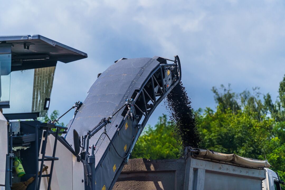Milling machine loading a haul truck in Dallas–Fort Worth, TX — Blackland Asphalt