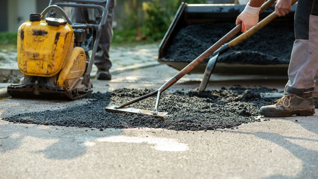 Crew raking hot mix asphalt in Dallas–Fort Worth, TX — Blackland Asphalt