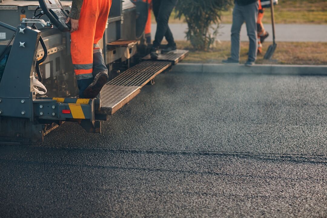 Paver and roller finishing a surface treatment in Dallas–Fort Worth, TX — Blackland Asphalt